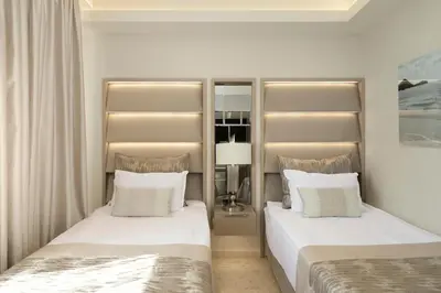a bedroom with two beds with white pillows at Hotel Residence Dune - Free Beach Access in Sunny Beach