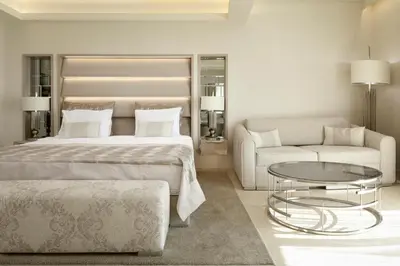 a bedroom with a bed and a couch and a table at Hotel Residence Dune - Free Beach Access in Sunny Beach