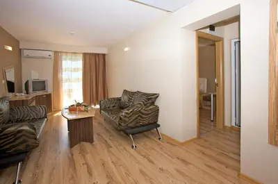 a living room with a couch and a chair at Hotel Kotva - All Inclusive in Sunny Beach
