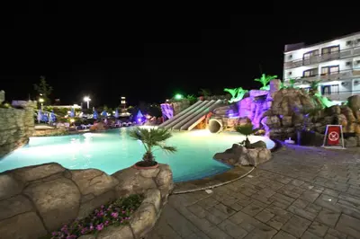 a swimming pool at night with a skate park at Hotel Kotva - All Inclusive in Sunny Beach