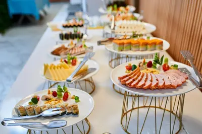 a long table with plates of food on it at Hotel Bavaro in Sunny Beach