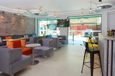 a restaurant with chairs and tables and a brick wall at Hotel Aktinia - All Inclusive in Sunny Beach