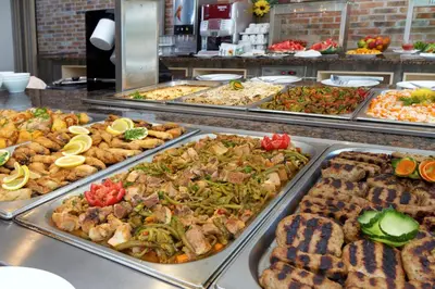 a buffet line with many different types of food at Hotel Aktinia - All Inclusive in Sunny Beach