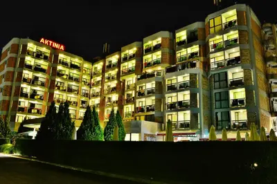 a large apartment building at night with its lights on at Hotel Aktinia - All Inclusive in Sunny Beach