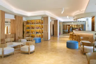 a lobby with chairs and tables and a bar at Hotel Nobel Ultra All Inclusive - FREE Beach Access in Sunny Beach