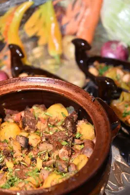 a bowl of food with meat and vegetables at Villas Ropotamo in Primorsko