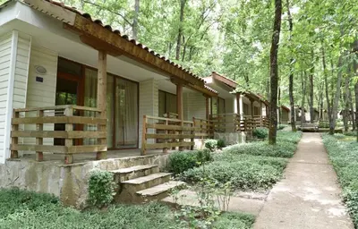 a house with a porch and stairs to the side of it at Villas Ropotamo in Primorsko