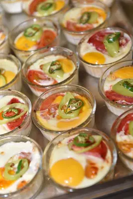 a bunch of small dishes with eggs and peppers at Villas Ropotamo in Primorsko