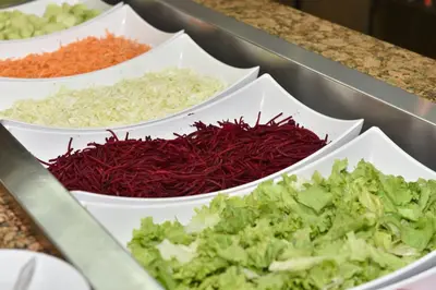 a counter with three white bowls filled with vegetables at Villas Holidays in Primorsko