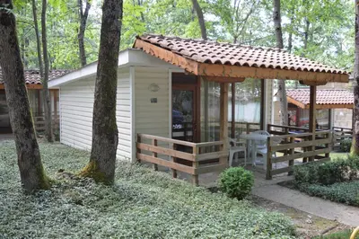 a cabin in the woods with a pergola at Villas Holidays in Primorsko