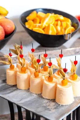 a bunch of cakes on a table with fruit at Hotel Sunny in Sozopol