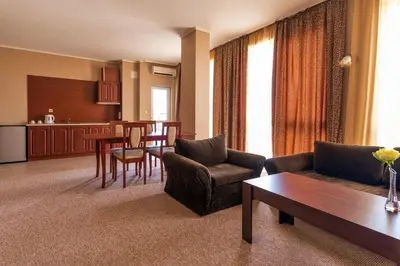 a living room with a couch and a table at Festa Pomorie Resort in Pomorie