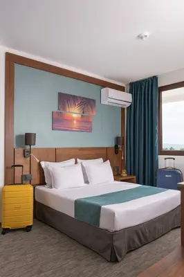 a bedroom with a large bed in a room at Hotel Pomorie Sun - All Inclusive in Sunny Beach