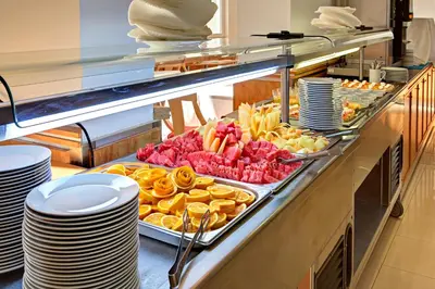 a buffet line with a variety of food on display at Hotel Fenix - All Inclusive in Sunny Beach