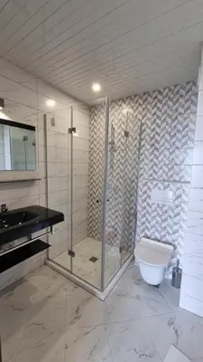 a bathroom with a shower and a toilet and a sink at Hotel Diamanti in Sozopol