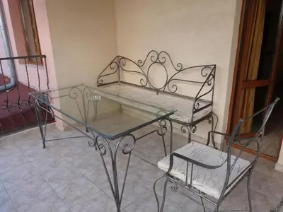 a glass table and a chair in a room at Hotel Beroe in Sveti Vlas