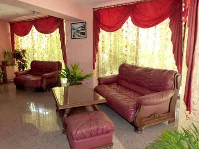 a living room with a leather couch and a table at Hotel Beroe in Sveti Vlas