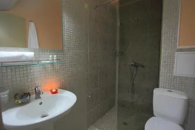a bathroom with a shower and a toilet and a sink at Hotel Rainbow 3 Resort Club in Sunny Beach