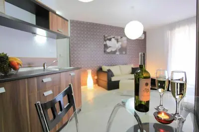 a bottle of wine on a table in a kitchen at Boutique Suites Rainbow 4 in Sunny Beach