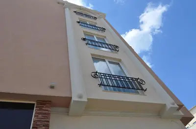 a tall building with a window and a balcony at Boutique Suites Rainbow 4 in Sunny Beach