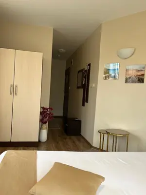 a room with a bed and a cabinet and a table at Hotel Silver in Sozopol