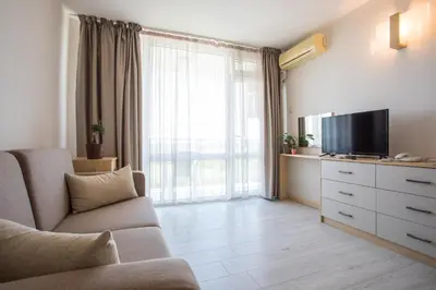 a living room with a couch and a television at Hotel Coop - Kiten in Kiten