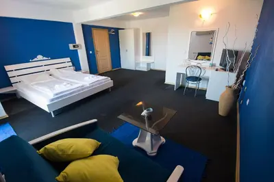 a room with a bed and a couch and a table at Family Hotel Four Seasons Tsarevo in Tsarevo