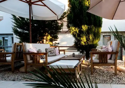 a patio with chairs and a table and an umbrella at The chill House in Sunny Beach in Sunny Beach
