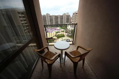 a balcony with a white table and two chairs at Menada Apartments in Royal Beach in Sunny Beach