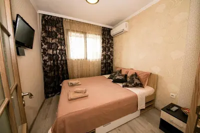 a small bed in a small room with a window at Cathedral Apartment Varna in Varna City