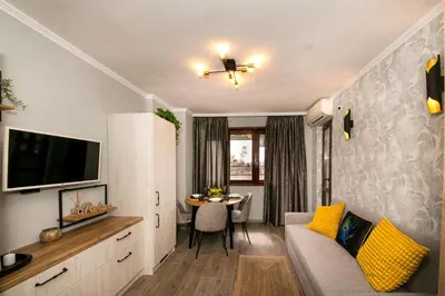 a living room with a couch and a table at Cathedral Apartment Varna in Varna City