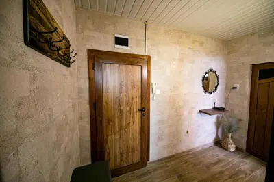 a hallway with a wooden door and a mirror at Cathedral Apartment Varna in Varna City
