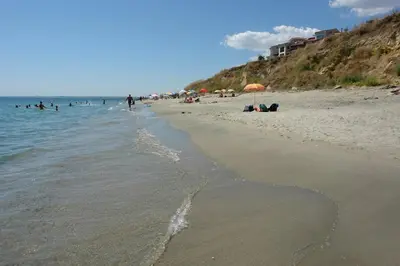 a beach with people in the water and people swimming at Visit Sunny Beach Marina Apartments in Ravda