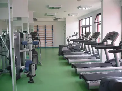 a gym with a row of treadmills and machines at Visit Sunny Beach Marina Apartments in Ravda