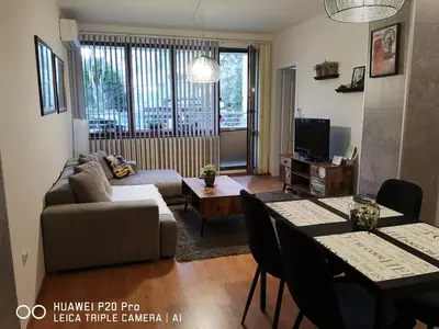 a living room with a couch and a table at Sea Garden Apartment IDM in Varna City