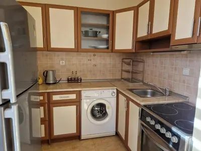 a kitchen with a washing machine and a sink at Apartment Kalin complex Aurelia-RAVDA in Nesebar