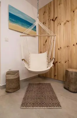 a hammock hanging in a room with a rug at The Poolhouse in Sunny Beach