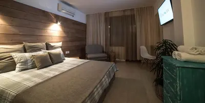 a bedroom with a large bed with a wooden headboard at The Poolhouse in Sunny Beach