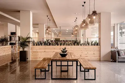 a dining room with a table and potted plants at Sunny Beach Club - Adults Only #YouthfulVibes in Sunny Beach