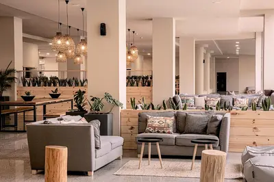 a lobby with couches and tables and potted plants at Sunny Beach Club - Adults Only #YouthfulVibes in Sunny Beach