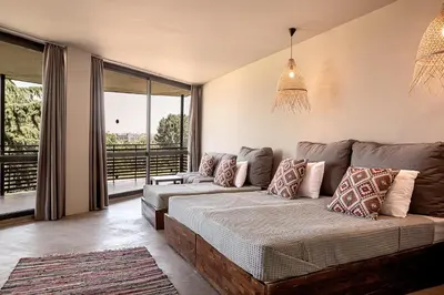 a living room with a couch and a large window at Sunny Beach Club - Adults Only #YouthfulVibes in Sunny Beach