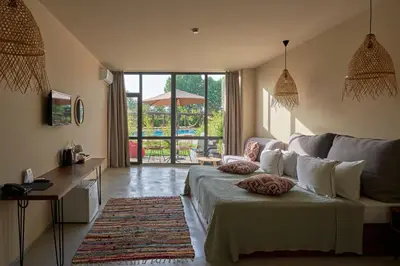 a living room with a bed and a couch at Sunny Beach Club - Adults Only #YouthfulVibes in Sunny Beach