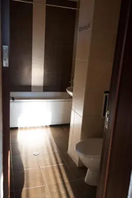 a bathroom with a toilet and a sink and a tub at Complex Apolon in Nesebar