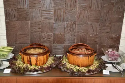 two large pots of food on a table at Hotel Neva in Kiten