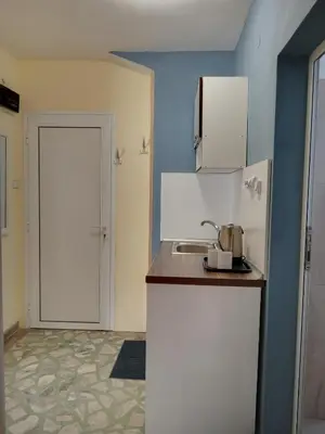 a small kitchen with a sink and a door at Guesthouse Oasis in Kiten