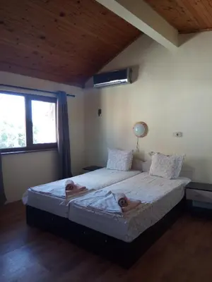 a bedroom with two people laying on a bed at Guesthouse Oasis in Kiten