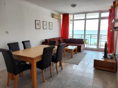 a living room with a table and chairs and a couch at Vega Village Ap B39 in Sveti Vlas