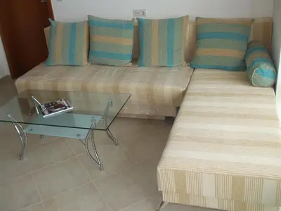 a couch and a glass table in a room at Samara Apartment in Lozenets