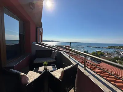 a balcony with a table and a view of the ocean at Family Hotel Radiana in Sozopol