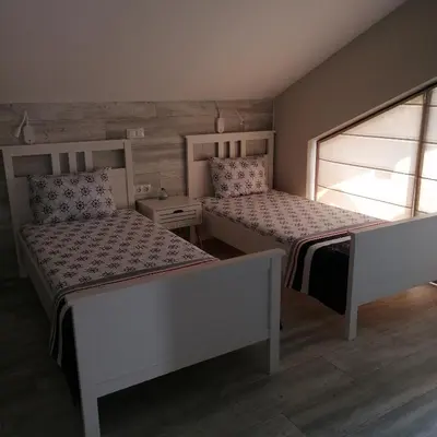 a bedroom with two beds and a window at Apartments Dona in Chernomorets